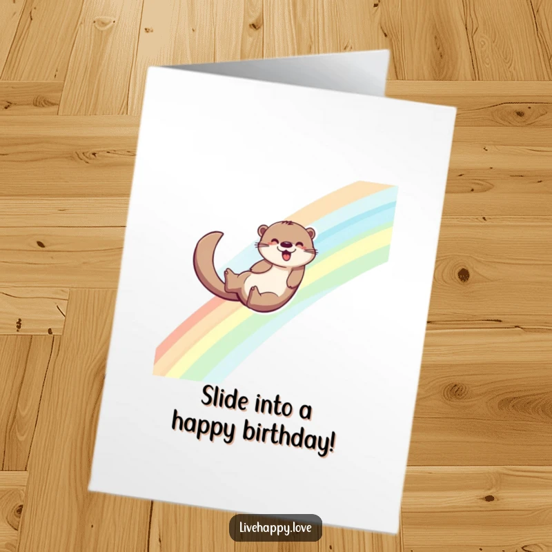 Funny Free Printable Birthday Card: Energetic otter joyfully sliding down a vibrant rainbow, leaving a trail of colorful joy.