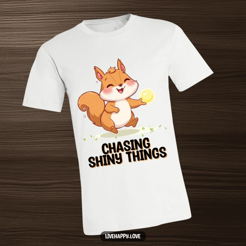 Funny Squirrel T-Shirt: A joyful squirrel with full cheeks intensely chases a glowing, sparkling orb of light with focused energy.